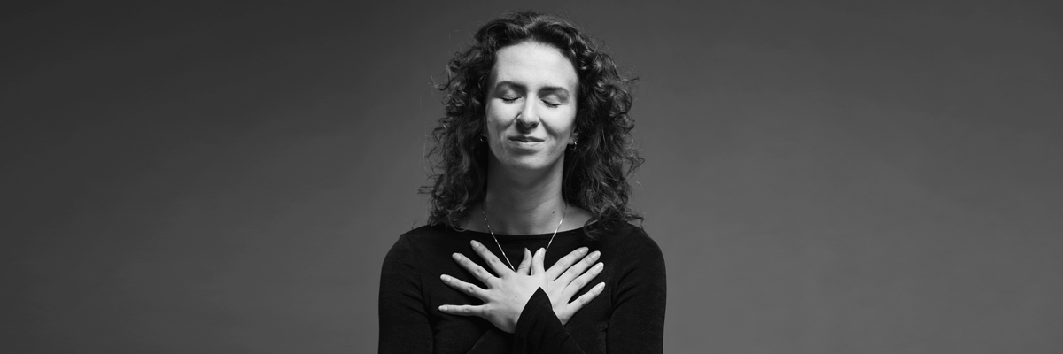 Woman with hands over her heart expressing gratitude