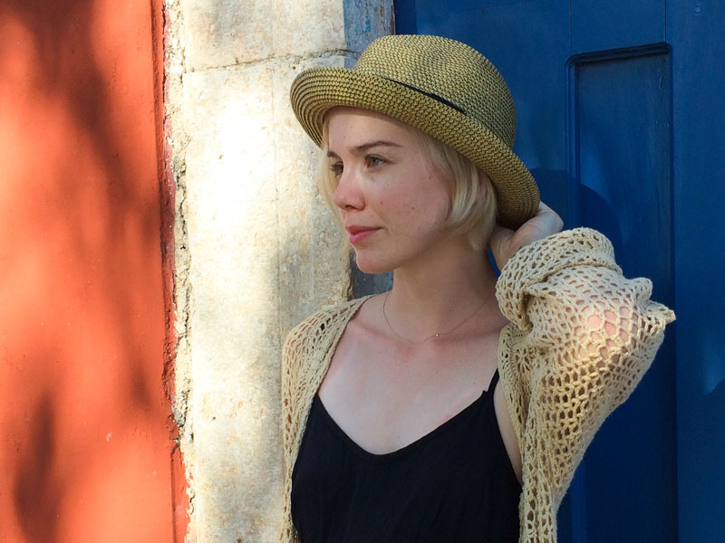 A blonde woman wearing a hat made by Toucan Hat company